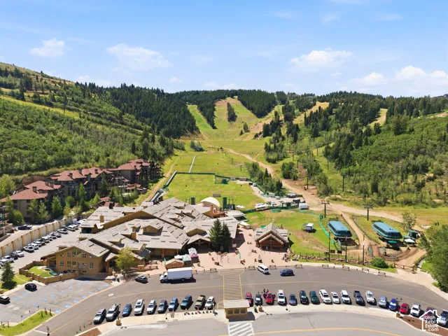 Expansive mountain setting featuring ski slopes, evergreen trees, and surrounding resort properties