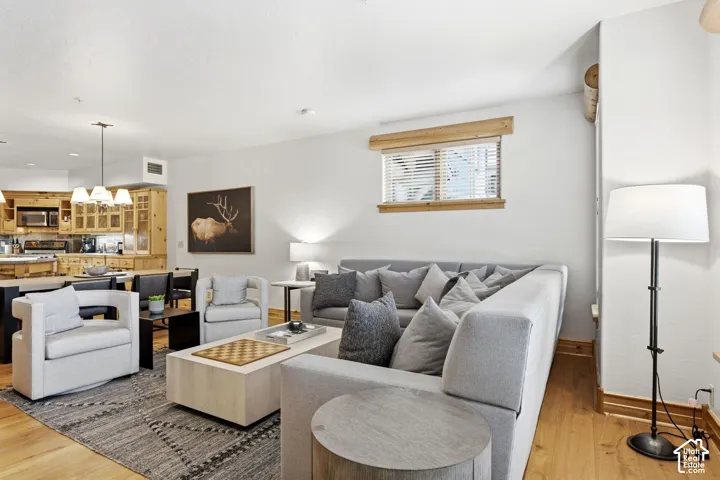 Open-concept living area featuring wood-finish flooring