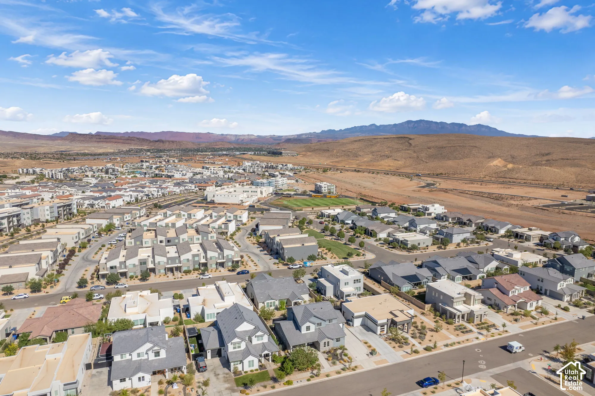Expansive residential development featuring varied architectural styles and arid landscape