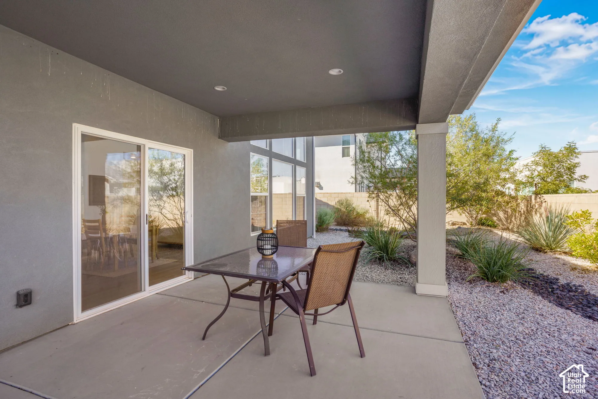 Covered patio featuring a concrete slab, recessed lighting, and sliding glass doors