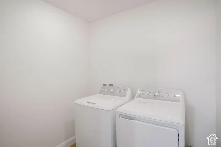 Laundry area featuring a top-load washing machine and front-load dryer