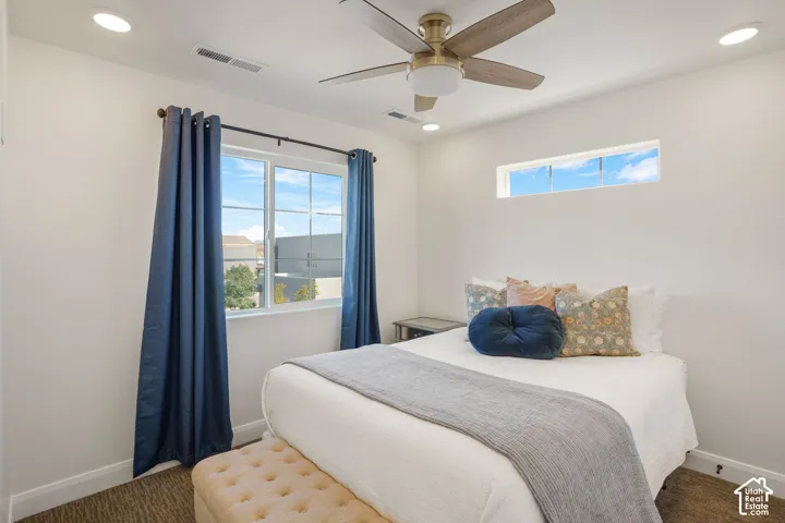 Recessed lighting, ceiling fan with light fixture, large window, high horizontal window, and carpet flooring