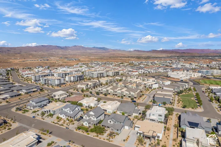 Expansive community featuring diverse architectural styles, paved roadways, and integrated green spaces