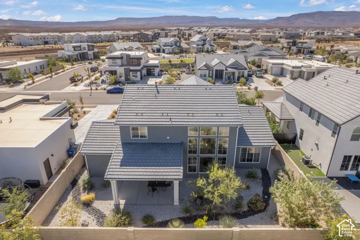 Two-story exterior with a covered patio, extensive window array, and tiled roofing