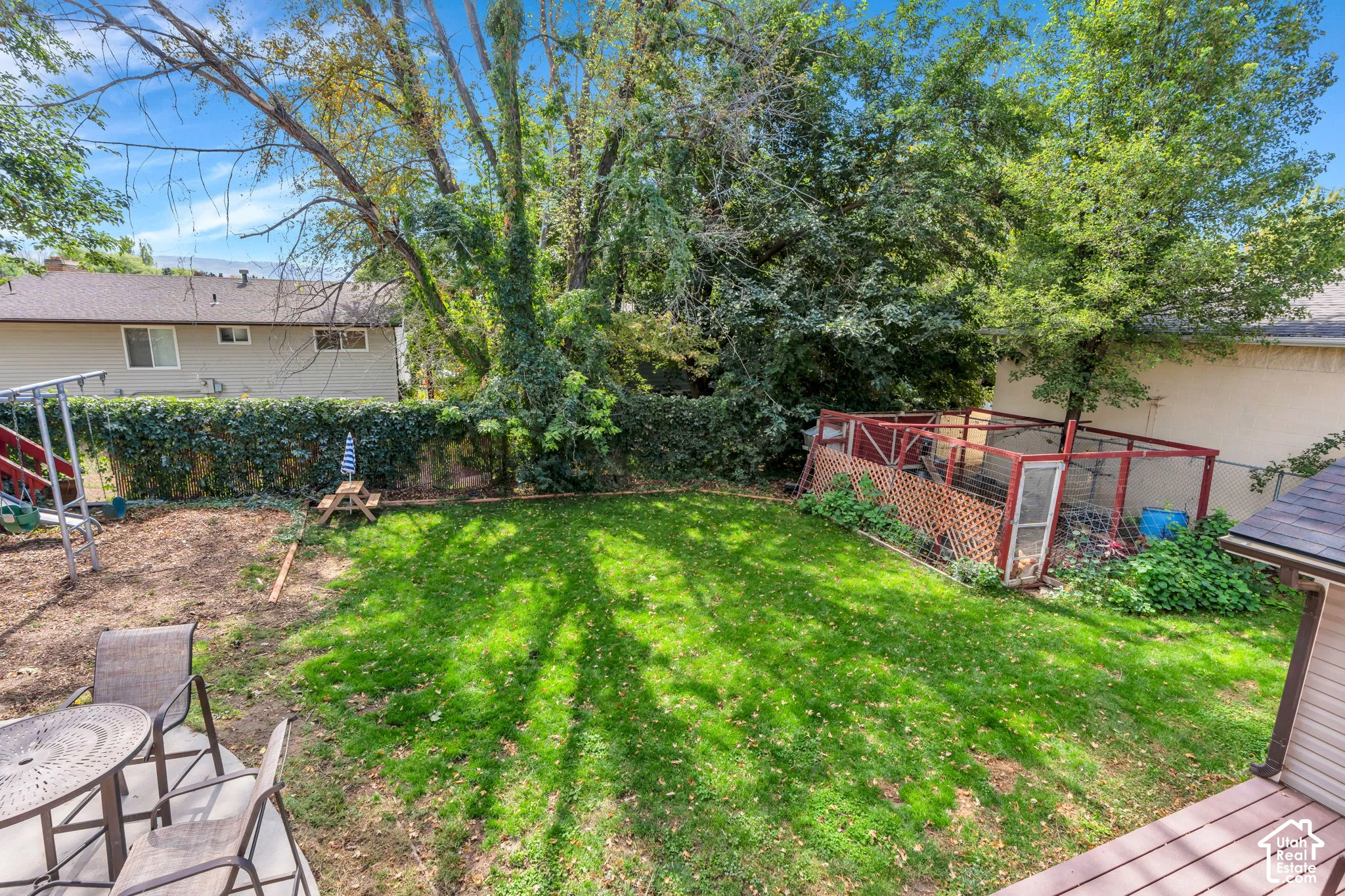 Manicured lawn area with mature trees providing shade