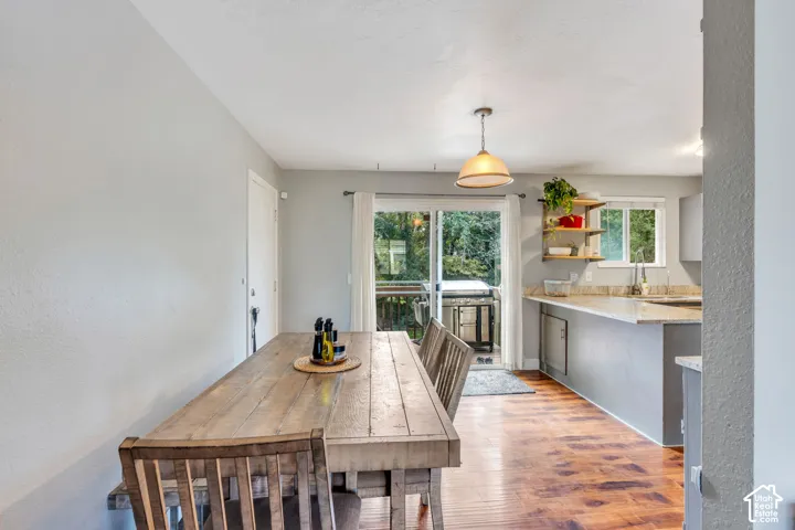 Wood-finish flooring throughout, with a sliding glass door leading to an outdoor deck