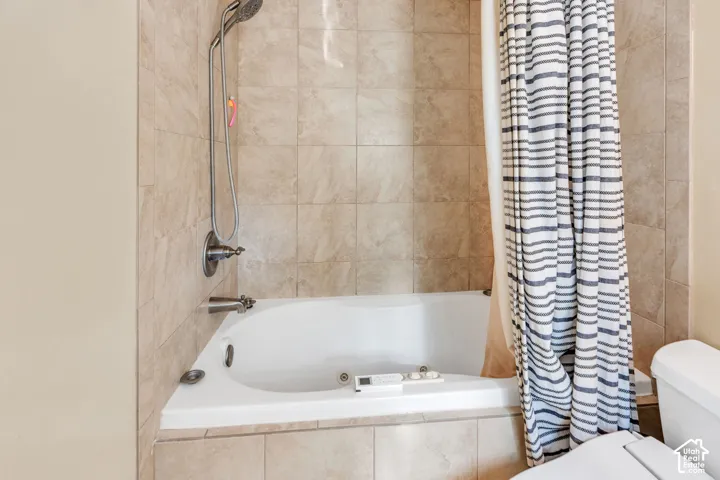 Tiled shower surround with a corner soaking tub and a brushed nickel shower fixture