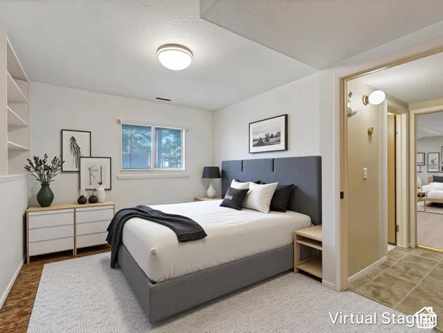 Interior room featuring built-in recessed wall shelving, a dual-pane window, flush-mount lighting, and wall-mounted light fixtures