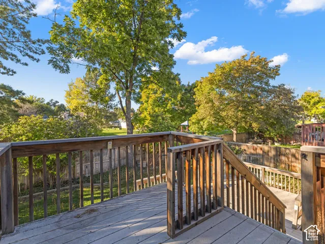 Expansive outdoor deck with wood railing and stairs