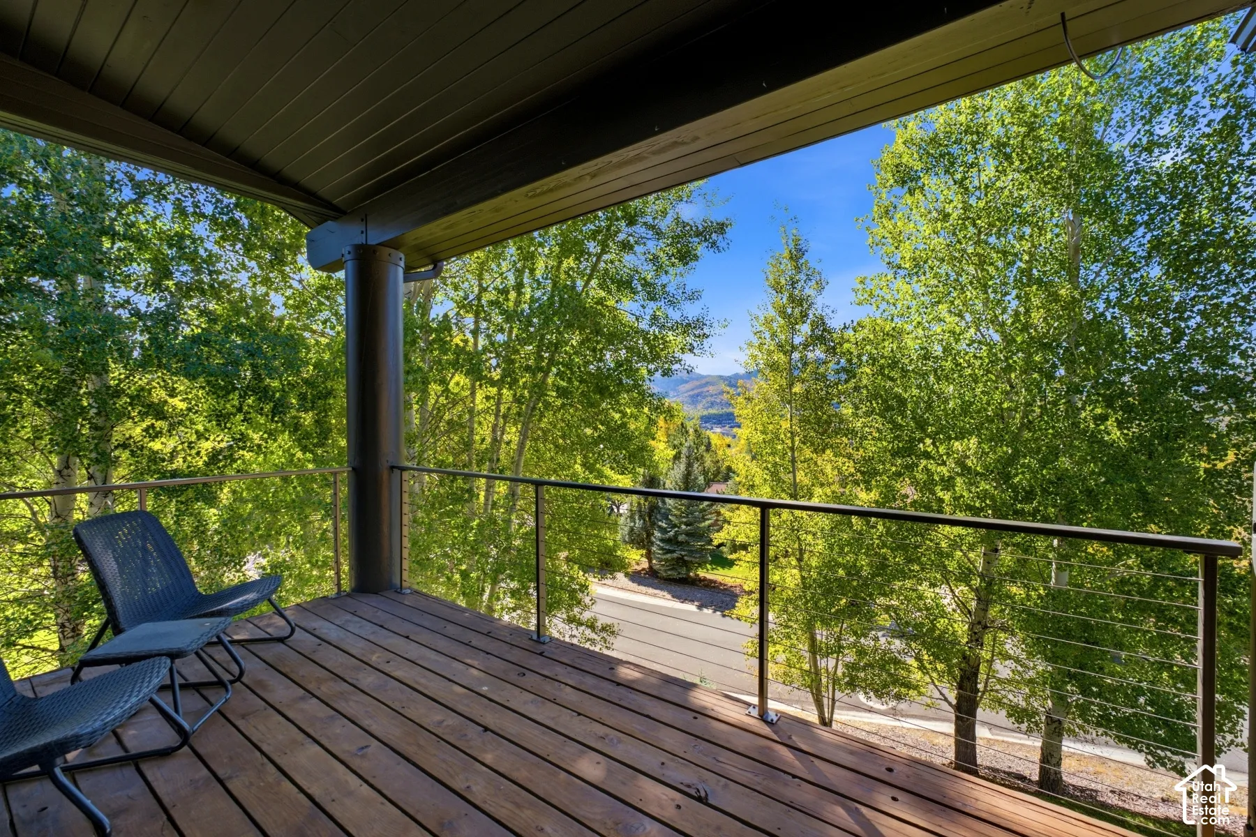 Covered wood-finish deck with cable railing