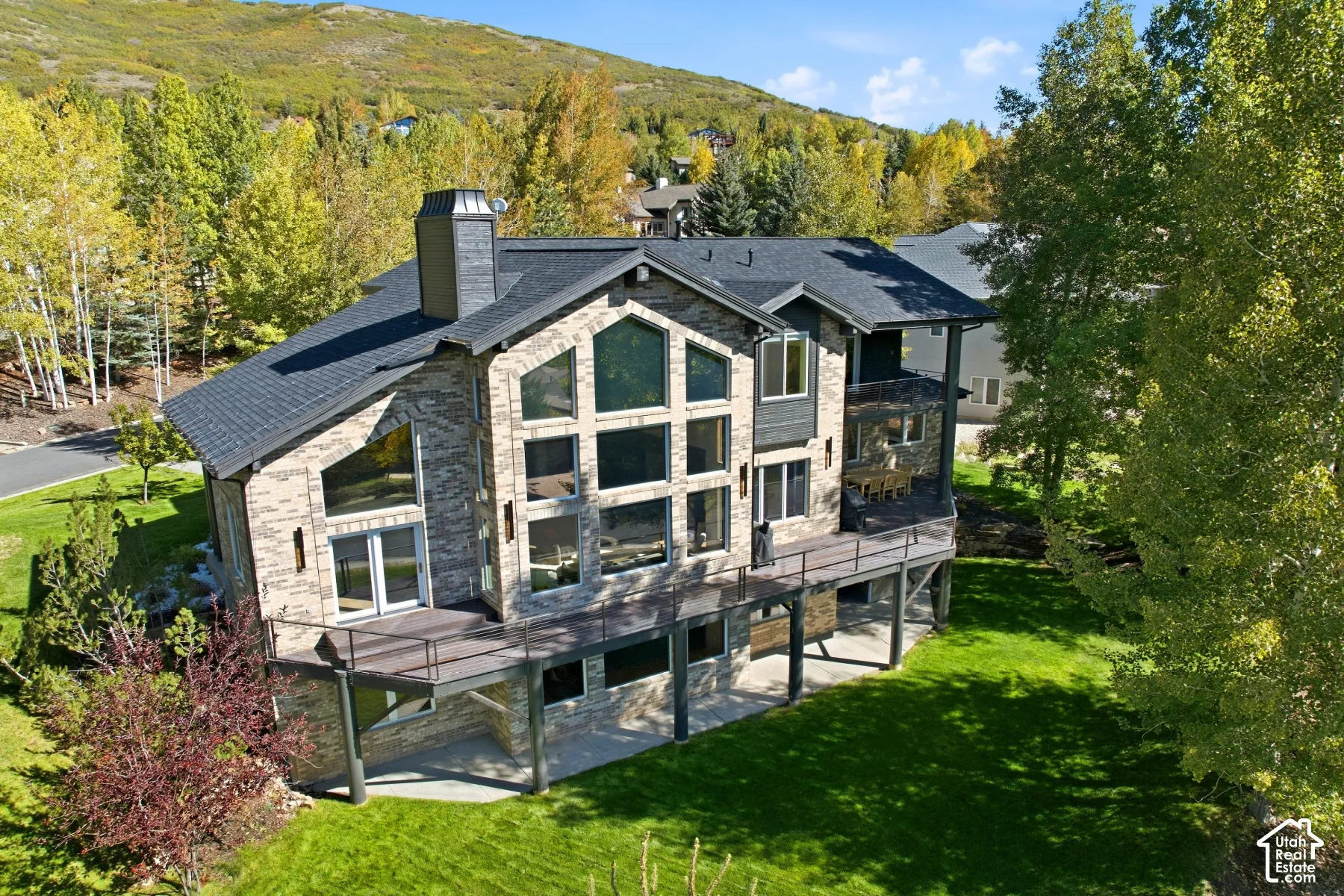 Stone-clad exterior with extensive window features and a multi-level deck