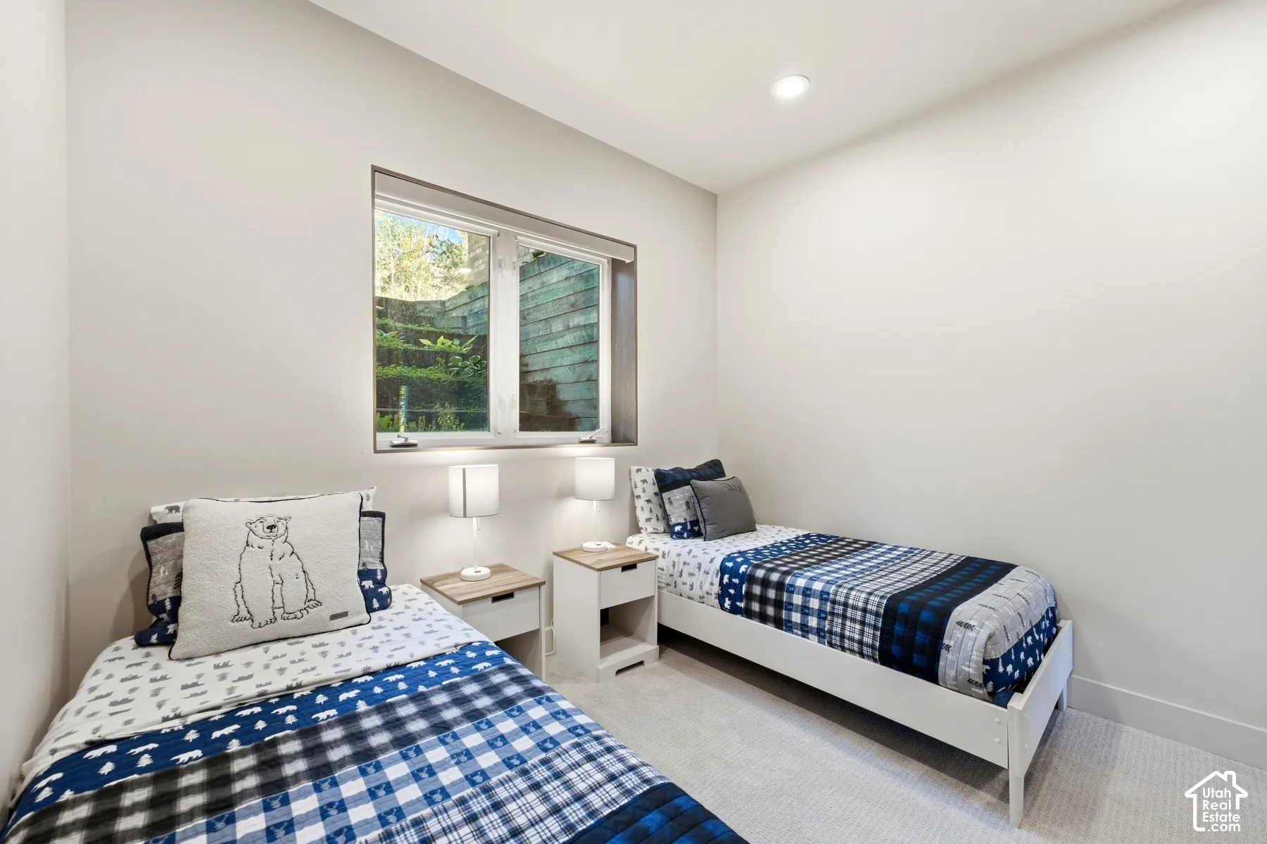 Recessed ceiling lighting, a single window, and light-colored carpeting