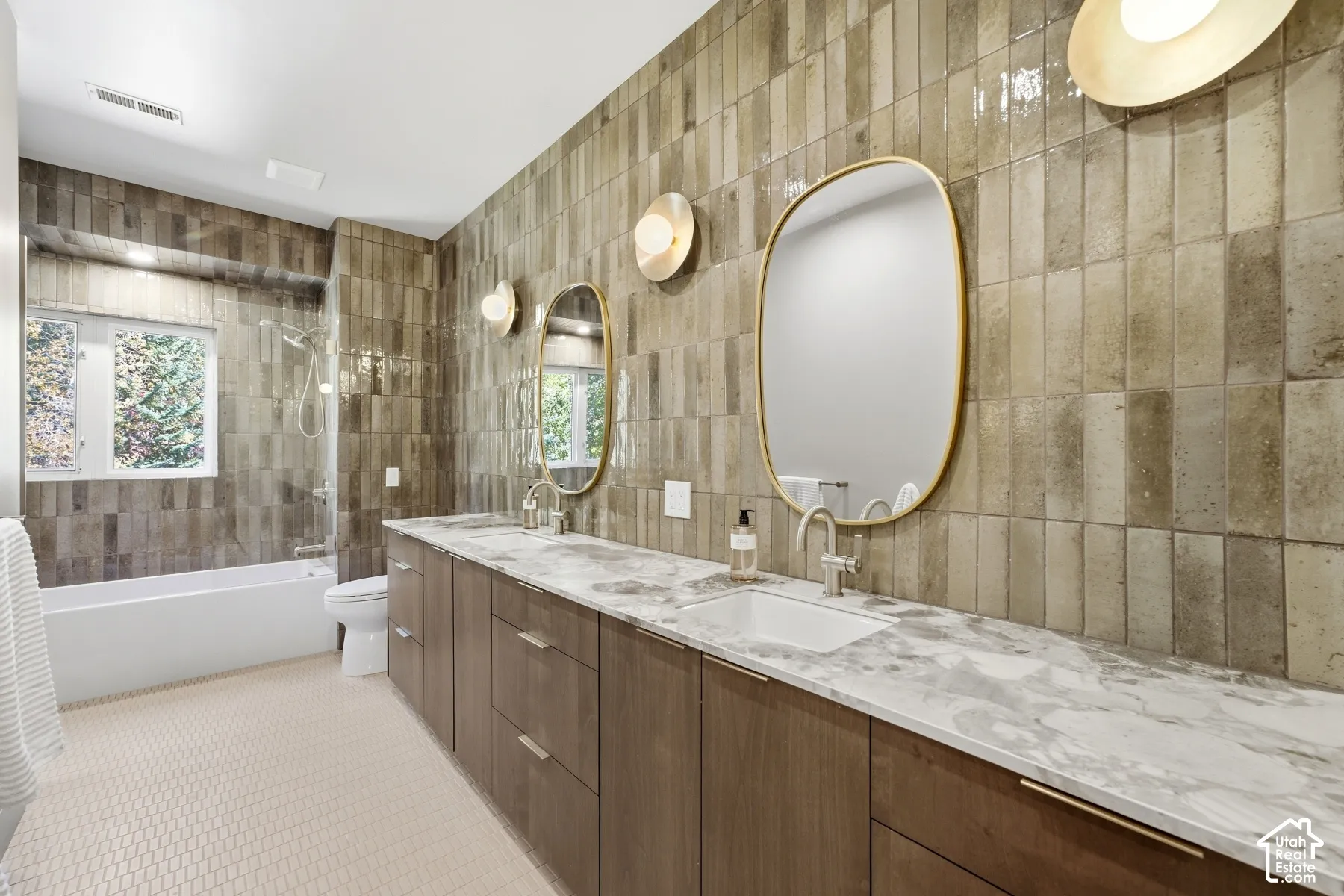 Dual vanity with light-toned countertop and integrated sinks