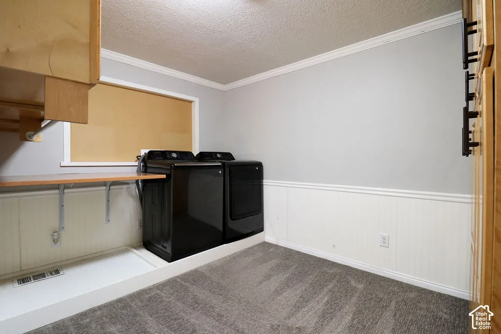 Laundry area featuring white beadboard wainscoting, light gray wall paint, and overhead wood cabinetry
