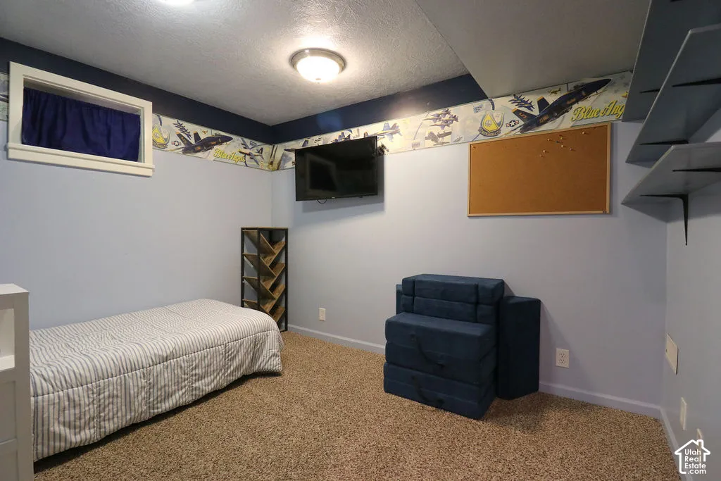 Recessed window with white trim, wall-mounted television, and built-in shelving