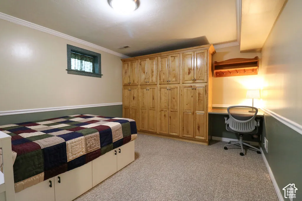 Built-in wood cabinetry, integrated desk, and window with a valance