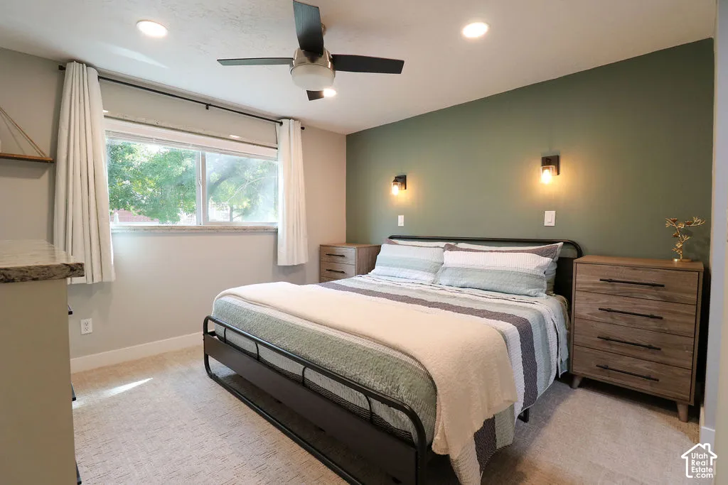 Recessed lighting, ceiling fan, and wall sconces provide ample illumination