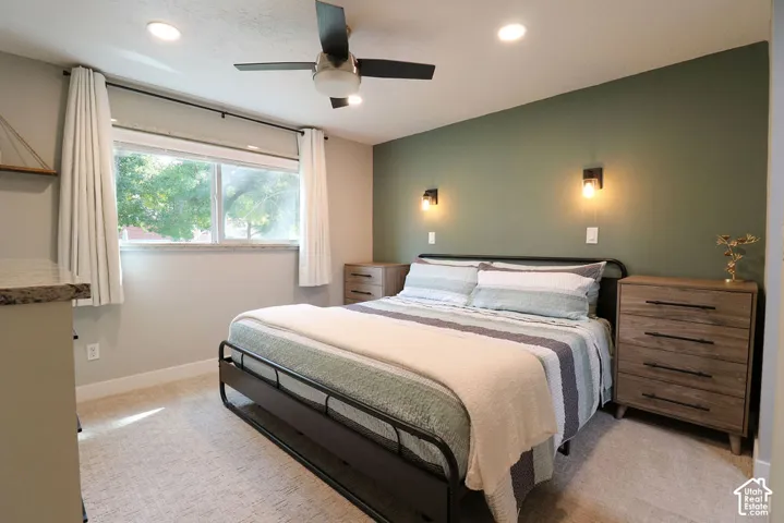 Recessed lighting, ceiling fan, and wall sconces provide ample illumination