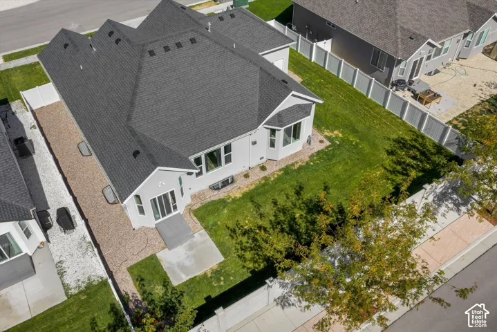 Newly constructed residence with a dark shingle roof, light-colored siding, and multiple windows