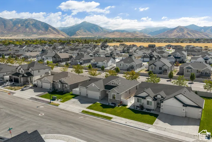 Neighborhood setting with uniform residential architecture and mountainous backdrop