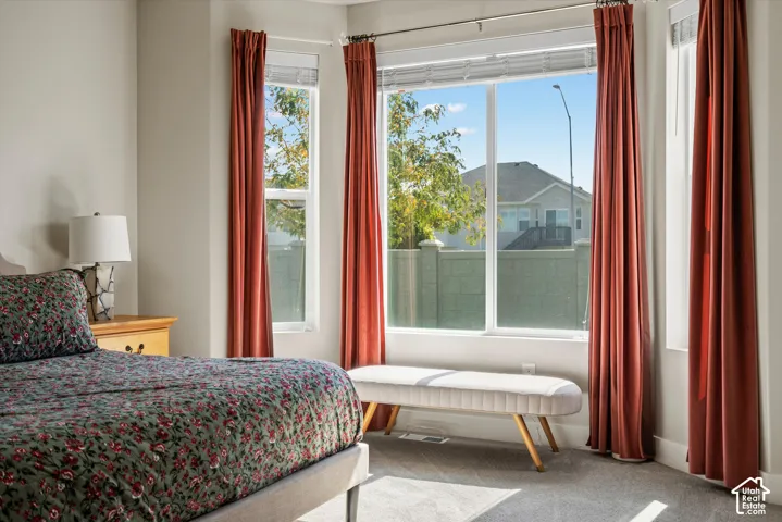 Large windows, light gray wall paint, and gray carpeting
