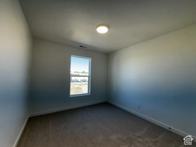 Carpeted flooring, single window, flush-mount ceiling light fixture, white walls