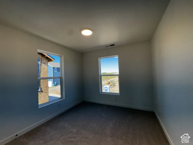 Neutral wall tones, recessed lighting, and two windows