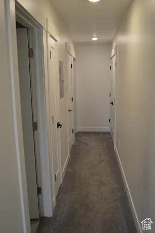 Recessed ceiling lighting, gray carpeting, white walls, white trim, and black door hardware