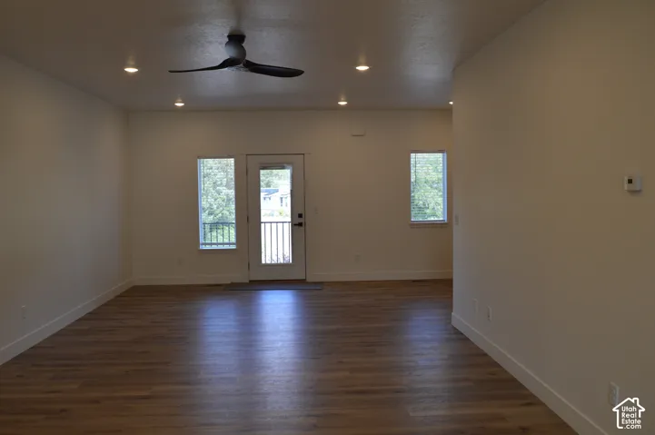 Spacious interior featuring wood-finish flooring, recessed lighting, and a contemporary ceiling fan
