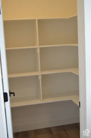 Built-in shelving with multiple levels, corner shelving, and wood-finish flooring