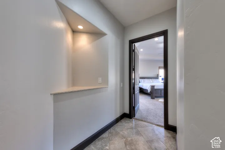 In-wall niche with recessed lighting and stone-look countertop