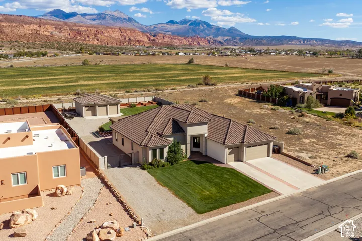 Single-story residence featuring a tile roof and attached two-car garage