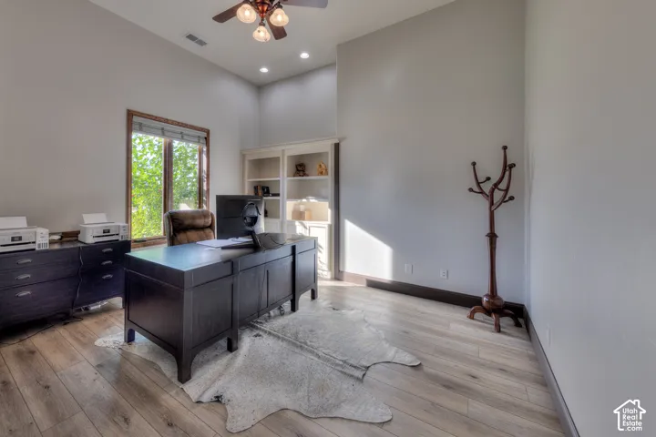 Wood-finish flooring, built-in shelving, vaulted ceilings, and recessed lighting