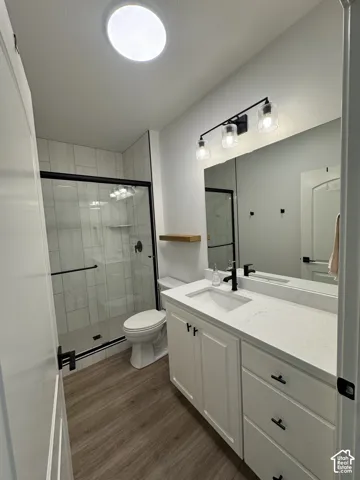 White vanity with a single basin sink and black faucet