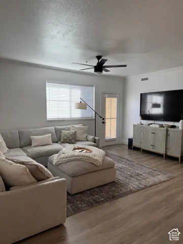Hardwood-finish flooring, crown molding, ceiling fan, and recessed lighting