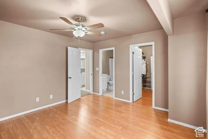 Hardwood-finish flooring, ceiling fan with integrated lighting, and neutral wall tones