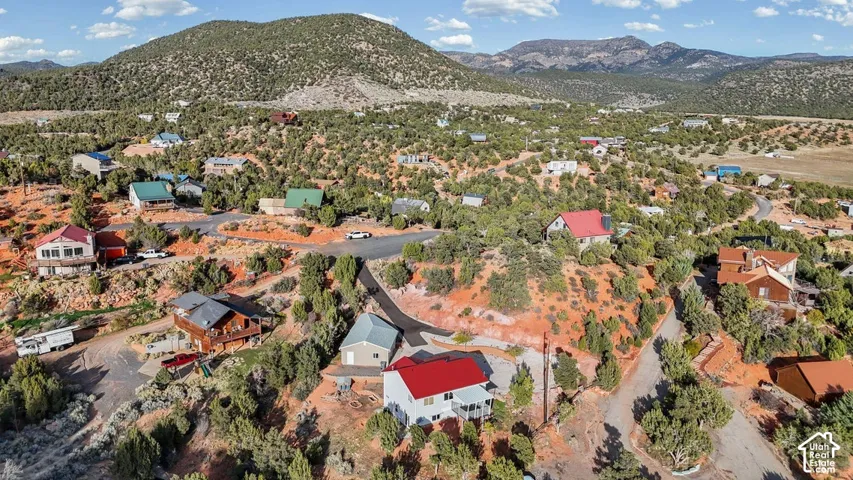 Rolling, arid landscape with scattered residential structures