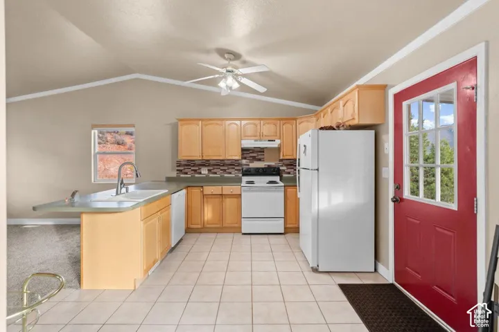 Kitchen featuring wood cabinetry, tile flooring, and a red paneled door with glass inserts