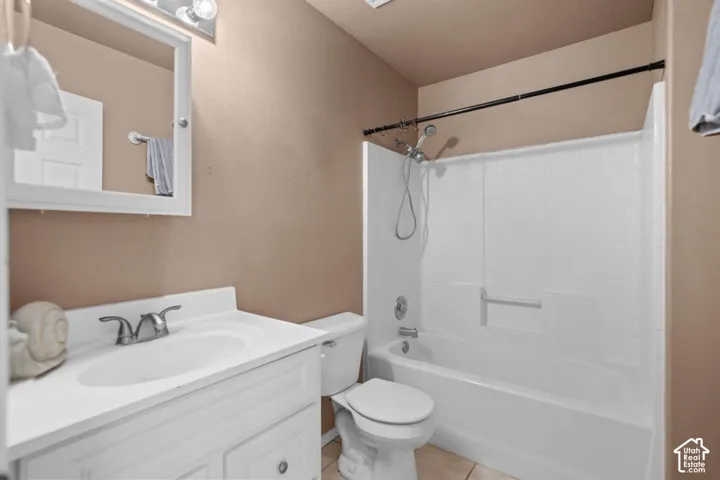 Vanity with integrated sink, chrome-finish faucet, and coordinating mirror with overhead lighting