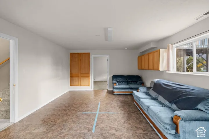 Recessed lighting, wood-finish flooring, built-in cabinetry, and a large window
