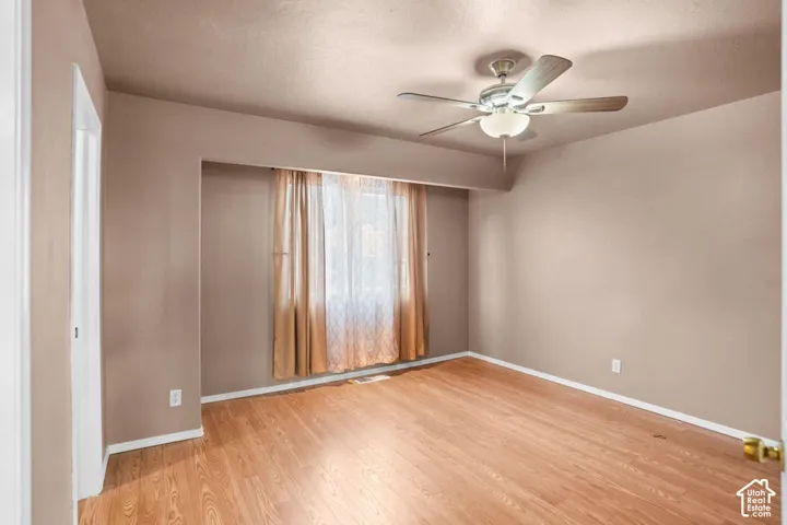 Wood-finish flooring with a ceiling fan light fixture