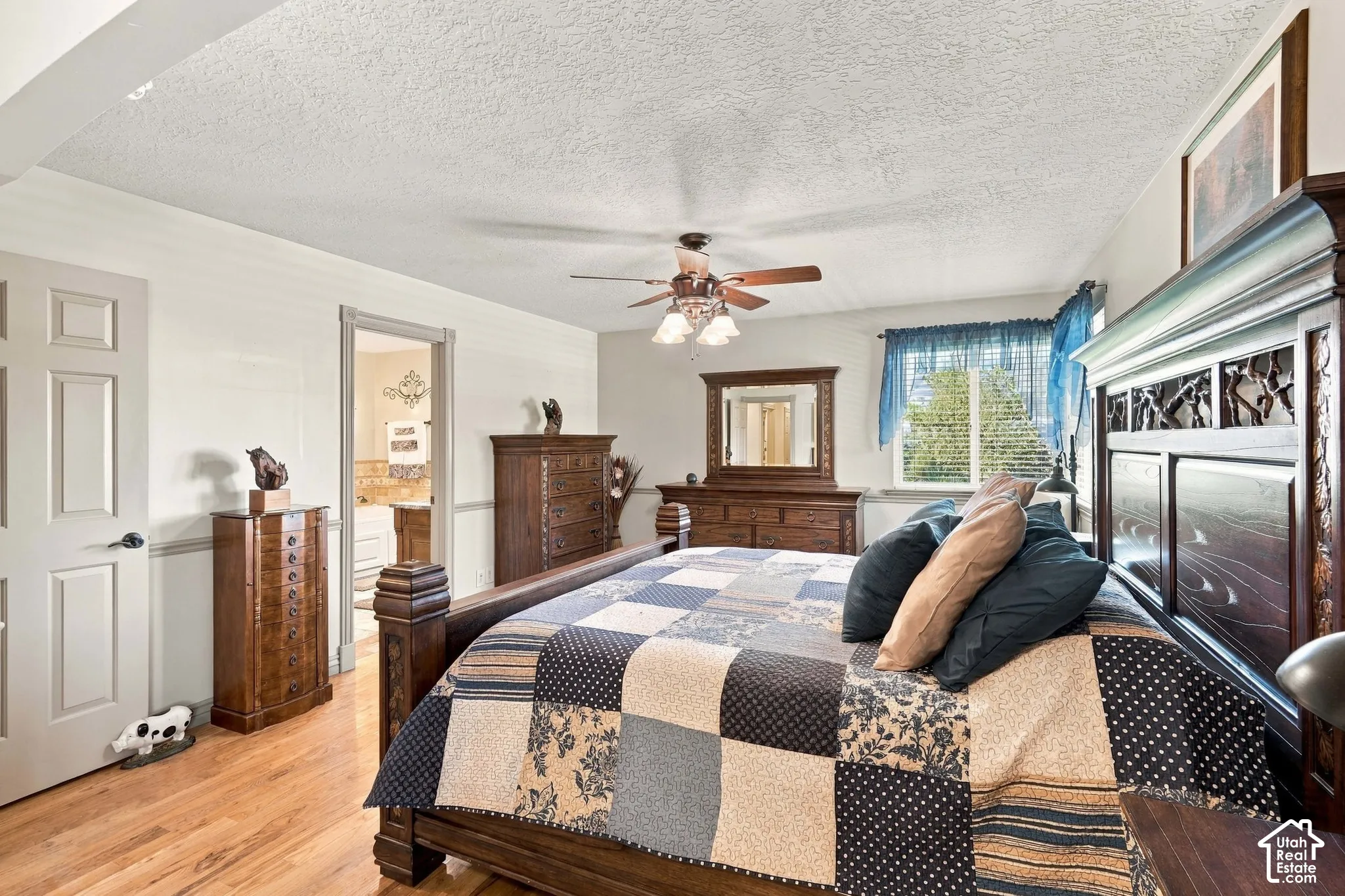Wood-finish flooring, ceiling fan with integrated lighting, and a window for natural light