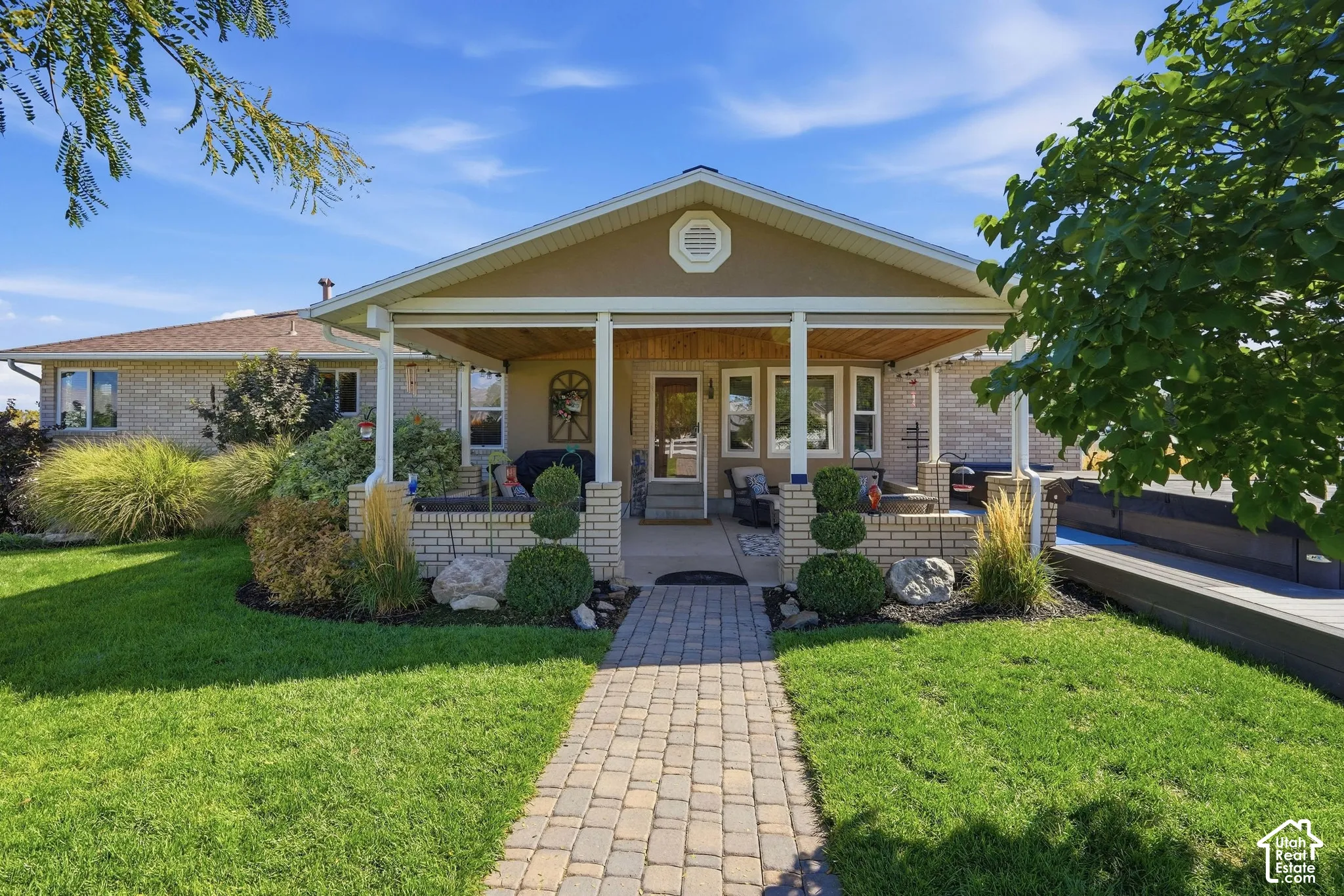 Covered front porch with brick column bases and a wood-finish ceiling