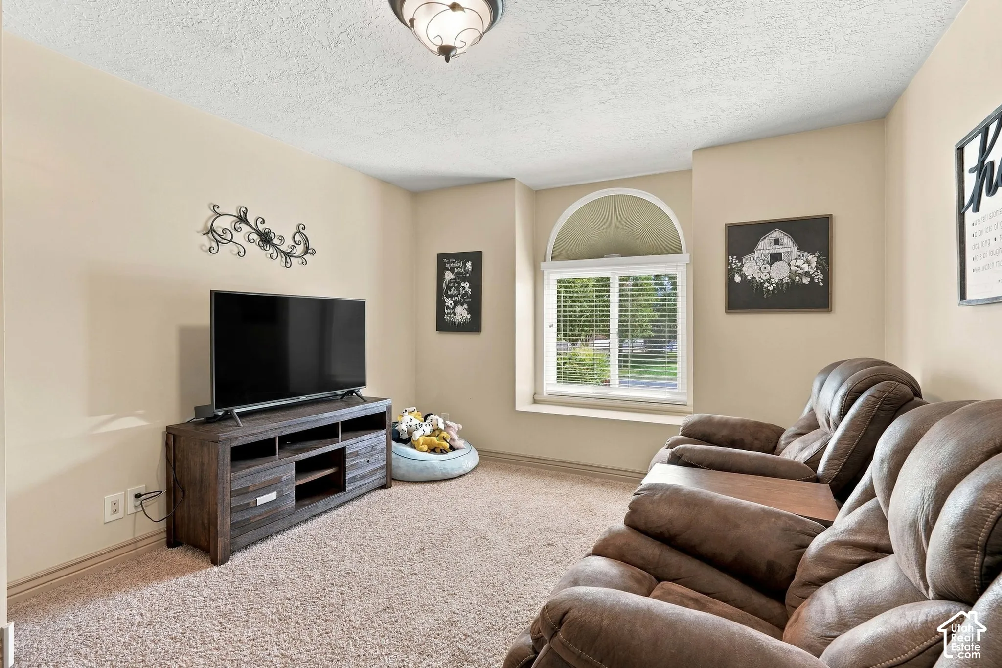 Carpeted room with a half-round window, vaulted ceiling, and recessed lighting