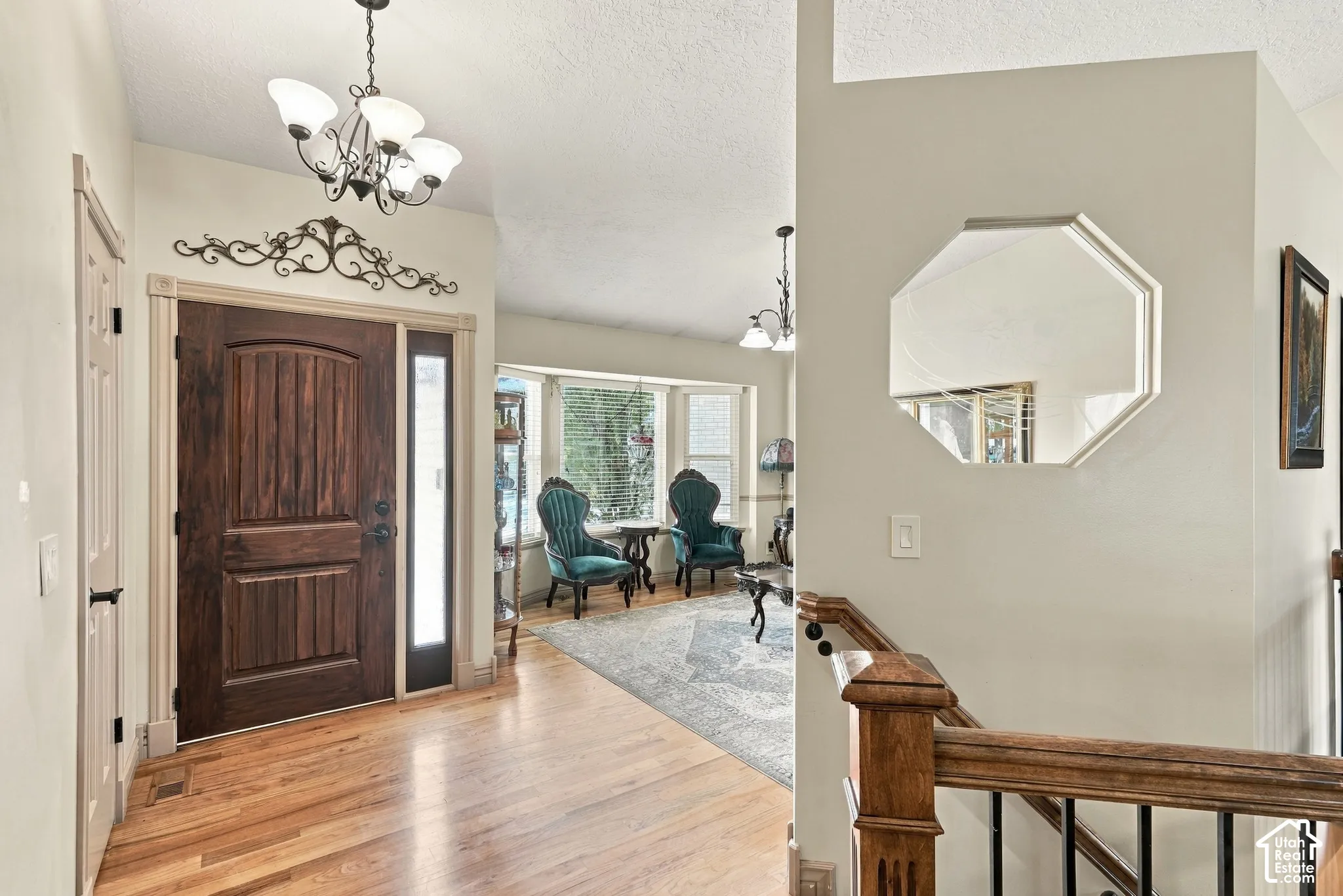 Solid wood entry door with vertical paneling, sidelight, and decorative transom