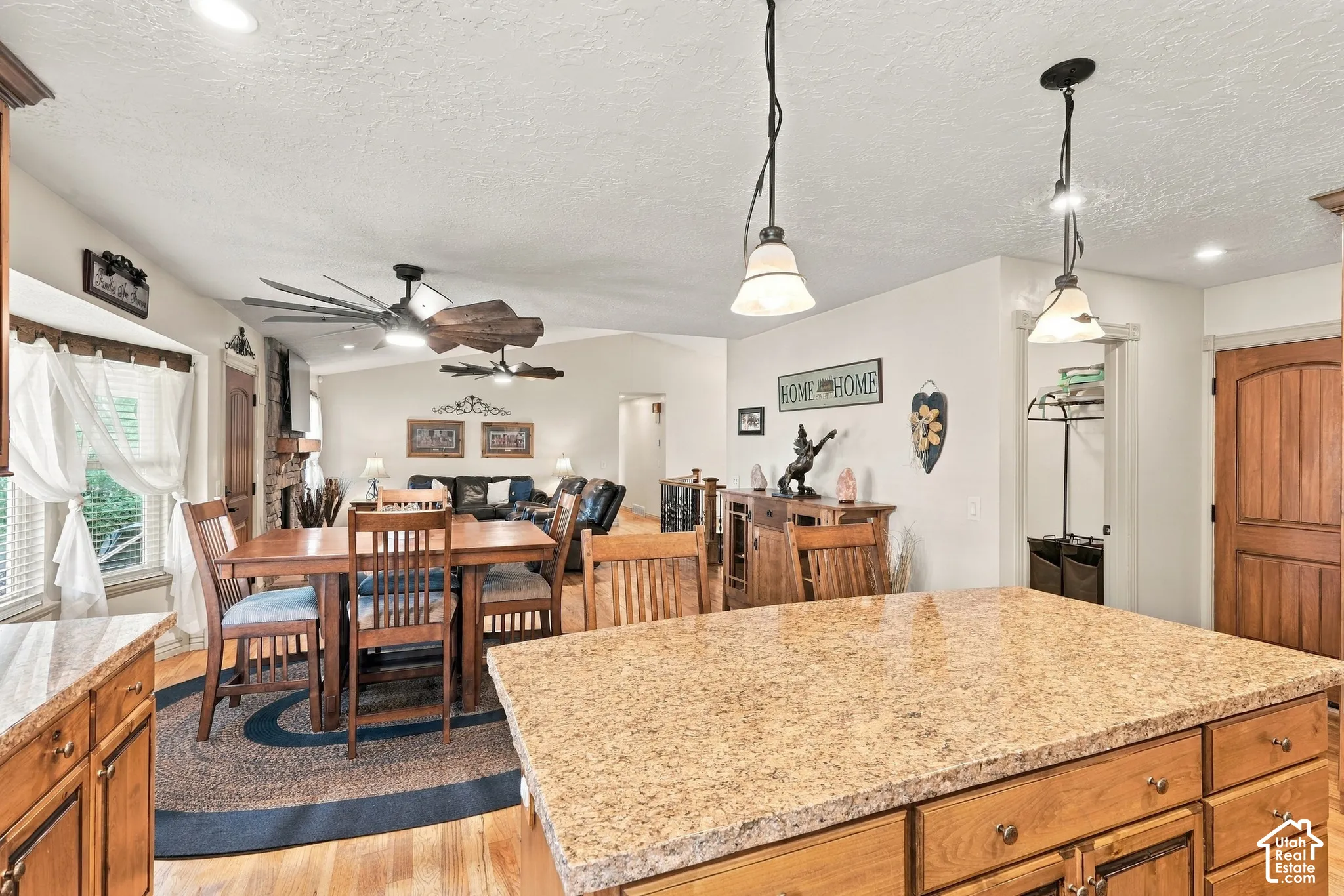 Kitchen island with a light-toned countertop and wood cabinetry