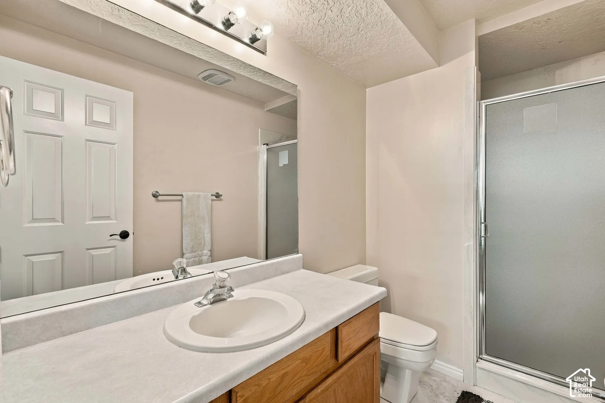 Vanity with an integrated sink, polished chrome faucet, and wood-finish cabinetry
