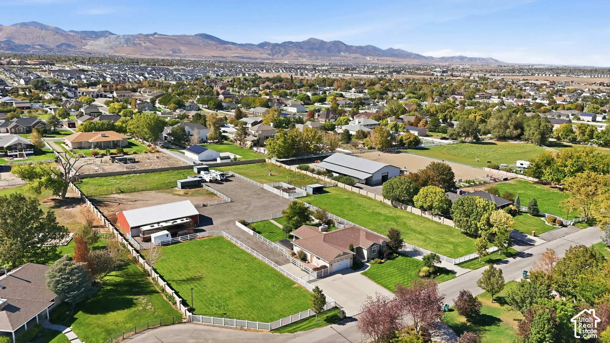 Expansive property featuring multiple outbuildings, fenced enclosures, and a large residential structure
