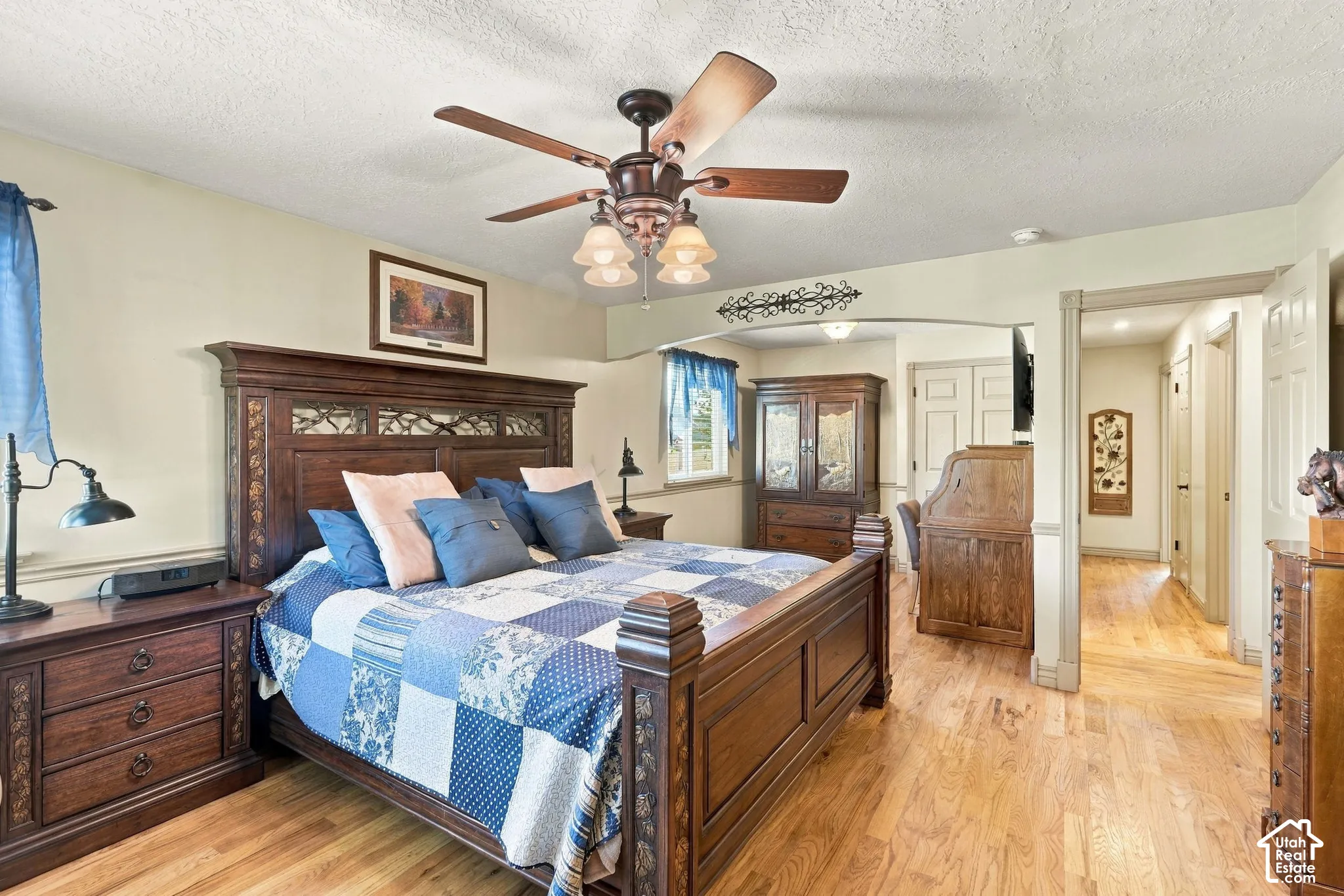 Hardwood flooring, ceiling fan with integrated lighting, window, and built-in closet storage