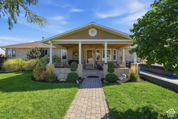 Covered front porch with brick column bases and a wood-finish ceiling